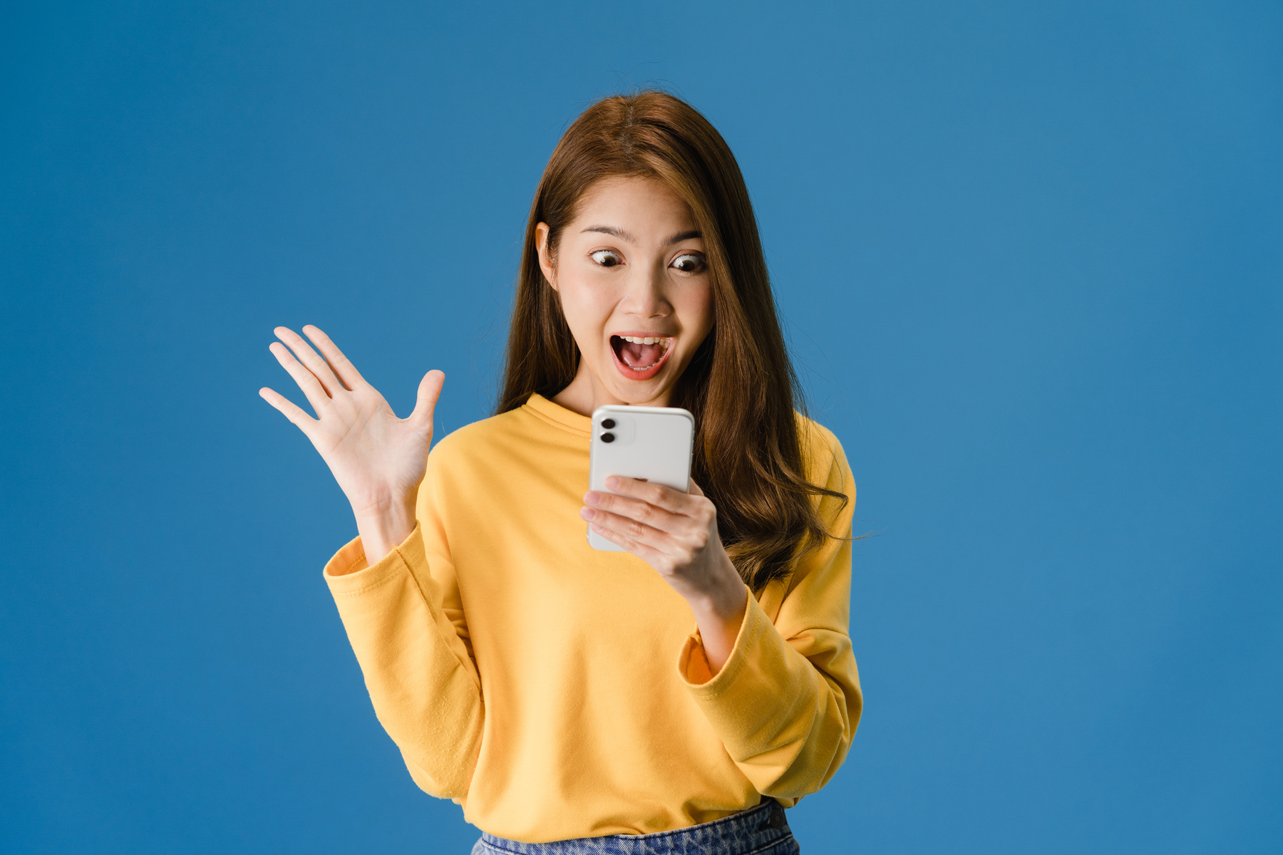 Surprised Young Lady using Mobile Phone